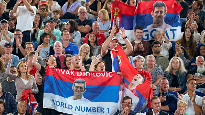 Fans supports Novak Djokovic with Serbian flags donning his face.